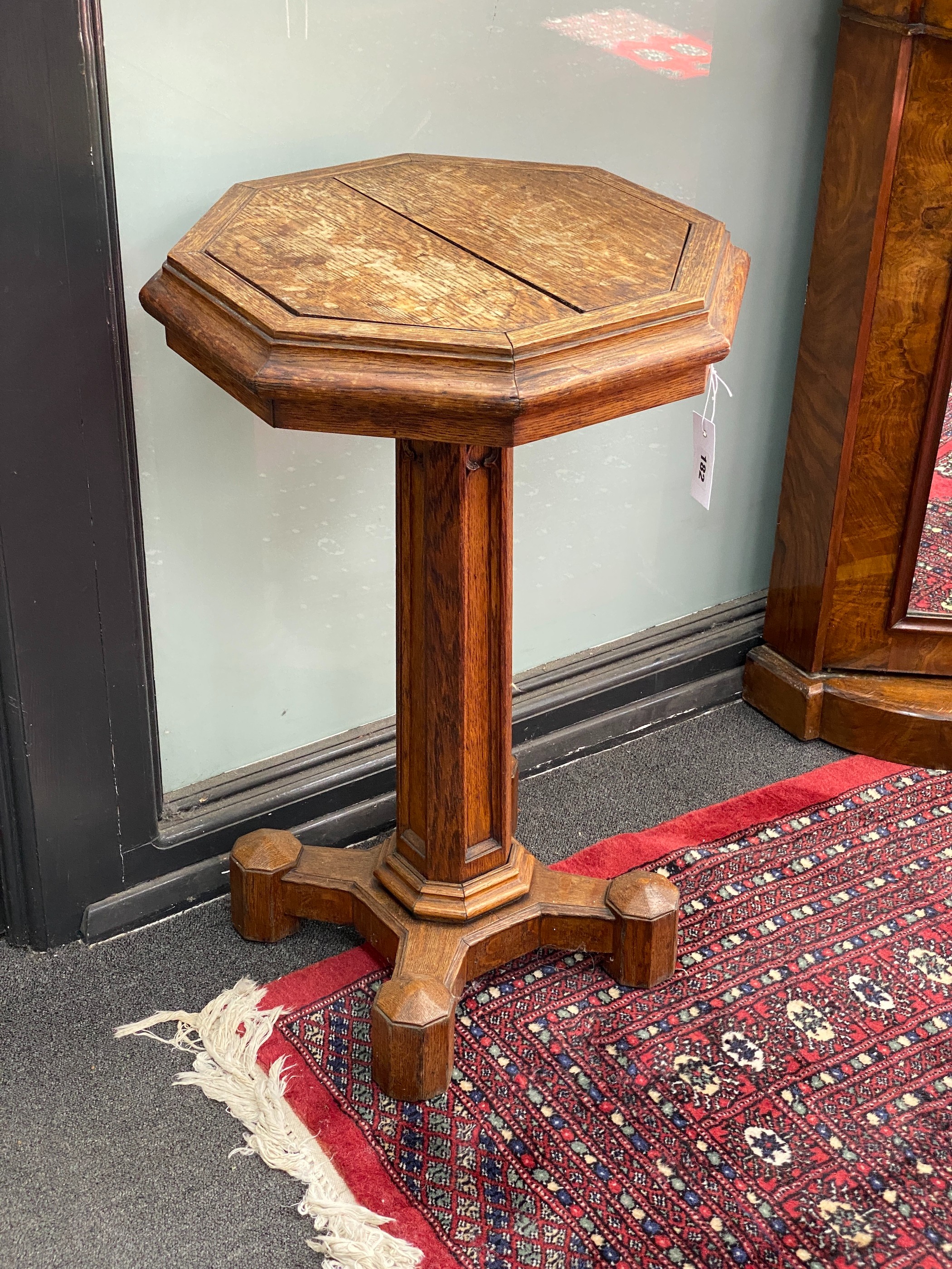 A Victorian Gothic style octagonal oak jardiniere table, width 45cm, height 72cm